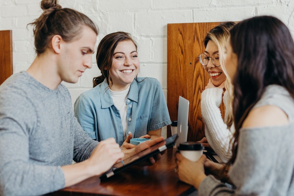 An advisor guiding students at a table